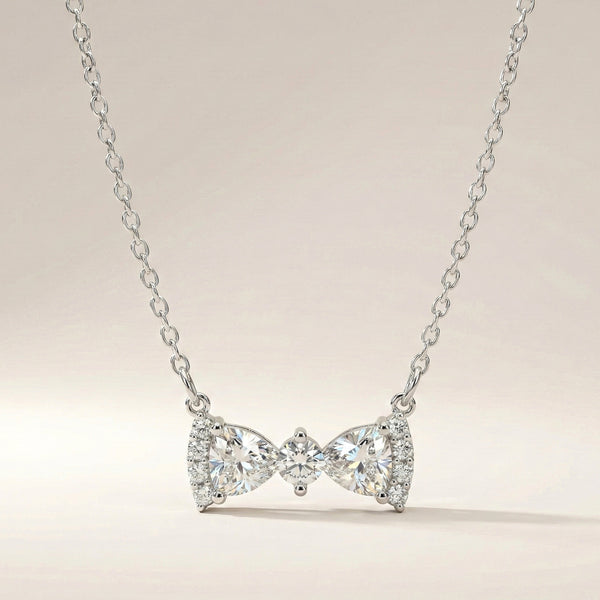 Luna Knot bow pendant with precision-cut stones and elegant gold finish by Evvara Vogue