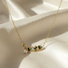 Midnight Muse gold necklace with black and green stones and pearl drop by Evvara Vogue