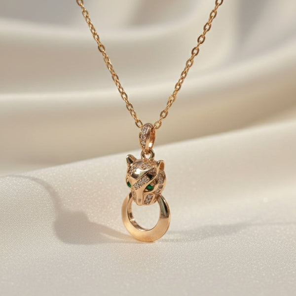 Panther head pendant necklace in gold finish with green eyes by Evvara Vogue