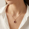Close-up of Scarlet Halo pendant showing ruby red stone and crystal halo by Evvara Vogue