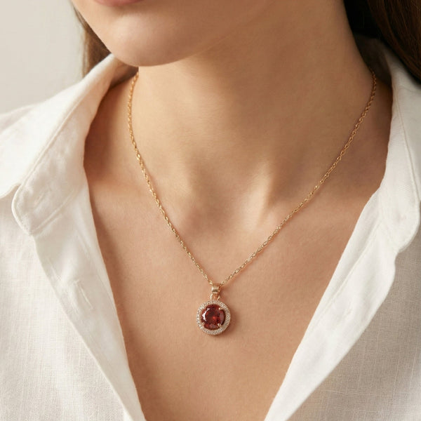 Close-up of Scarlet Halo pendant showing ruby red stone and crystal halo by Evvara Vogue