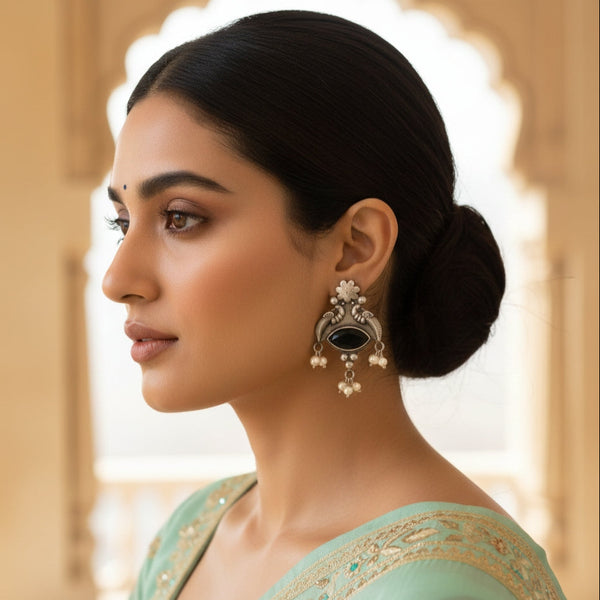 Woman wearing elegant earrings with a blurred background