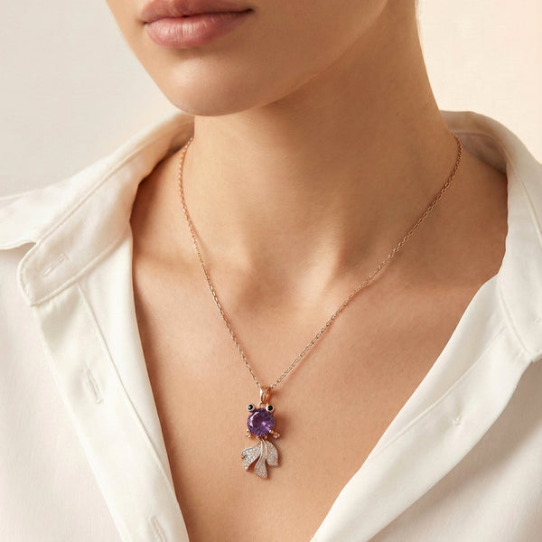 Close-up of Nocturne Muse purple gemstone pendant detailing in gold finish by Evvara Vogue
