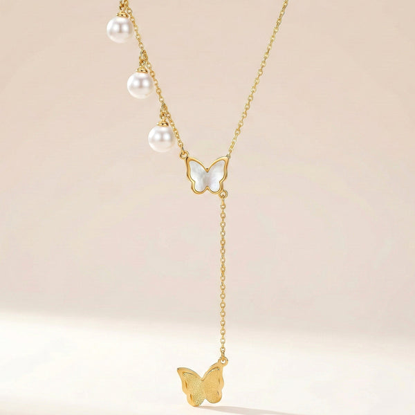 Minimal butterfly necklace layered with pearls elegant everyday jewellery design