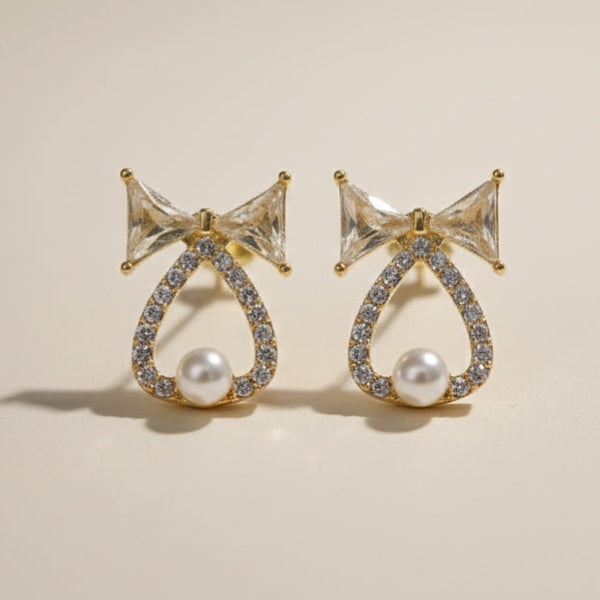 Gold tone bow pearl crystal stud earring