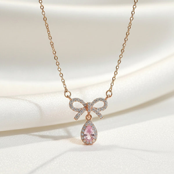 Gold bow necklace with blush pink teardrop stone