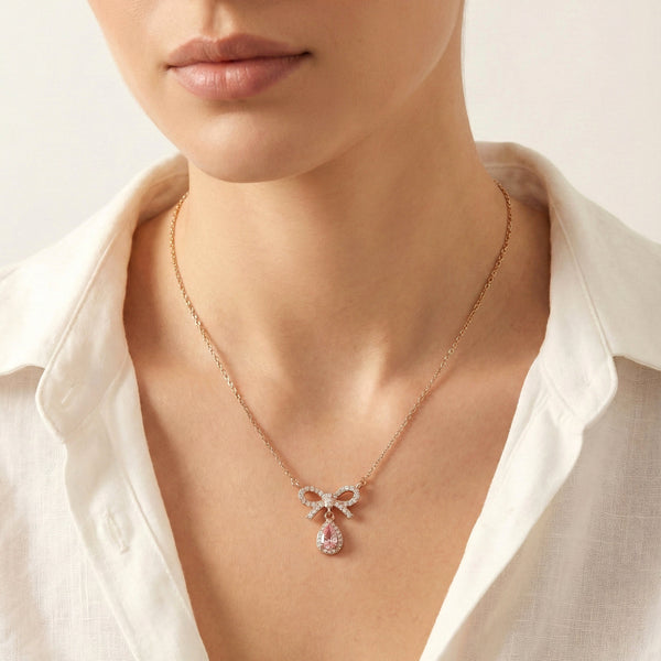 Elegant bow-shaped pendant necklace with pavé stones and pink drop
