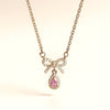 Minimal luxury pink teardrop necklace with gold bow detailing