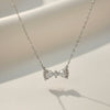 Luna Knot Necklace by Evvara Vogue featuring a delicate bow-shaped crystal pendant on a gold-tone chain