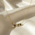 Midnight Muse gold necklace with black and green stones and pearl drop by Evvara Vogue