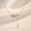 Butterfly pearl drop pendant necklace in gold-tone stainless steel
