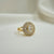 Oval halo crystal statement ring gold tone