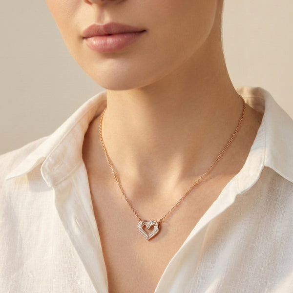 Evvara Twin Pulse heart pendant with pavé crystal detailing in rose gold finish