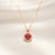 Scarlet Halo ruby red halo pendant in gold tone stainless steel by Evvara Vogue