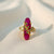 Ruby red statement ring with gold tone leaf design