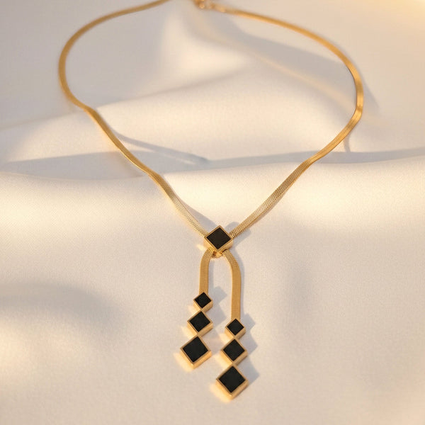 black square geometric pendants with gold chain detailing, Midnight Geometry necklace by Evvara Vogue