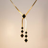 Midnight Geometry black geometric drop necklace in gold finish, anti-tarnish stainless steel by Evvara Vogue