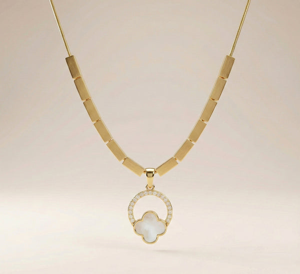 Elegant everyday clover necklace styled on satin background