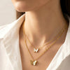 Minimal butterfly chain pendant with elegant gold finish on silk background by Evvara