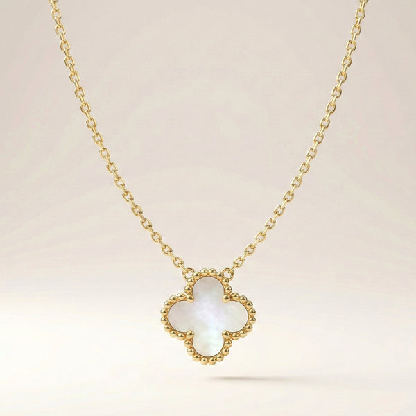 Elegant everyday clover necklace styled on fabric by Evvara Vogue