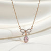 Gold bow necklace with blush pink teardrop stone